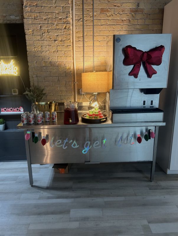 Drink station by the brick wall at Events On Main Co. event center in Magna, Utah